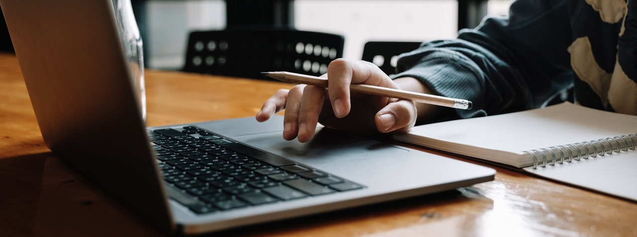 image of someone working using their laptop